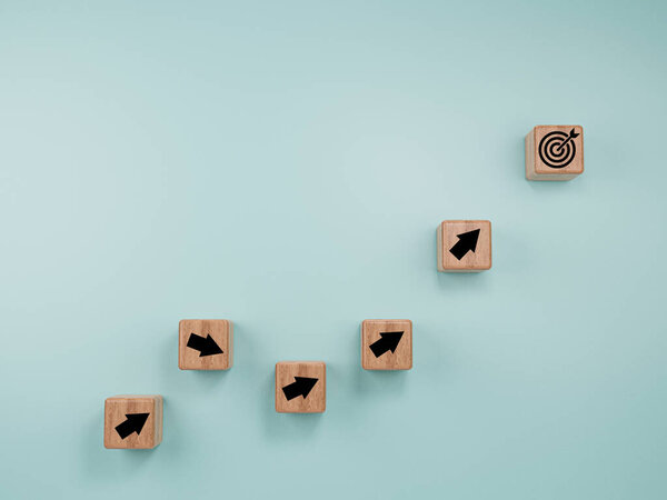 Virtual target board and arrow which print screen to wooden cube block on blue background. Business achievement goal and objective target concept.