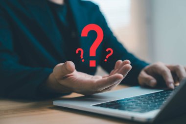 Dizüstü bilgisayarda çalışan iş adamı soru işareti sembolü ile problem çözme kararı, belirsizlik, SQ, müşteri desteği, iş stratejisi ve modern teknoloji kavramını temsil ediyor..