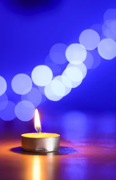 Tea candle and a blue bokeh — Stock Photo, Image