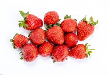 Bright red strawberry with green petals isolated on white background 