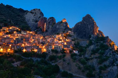 Beautiful small village Castelmezzano in dolomiti lucane on mountains at the blue hour clipart