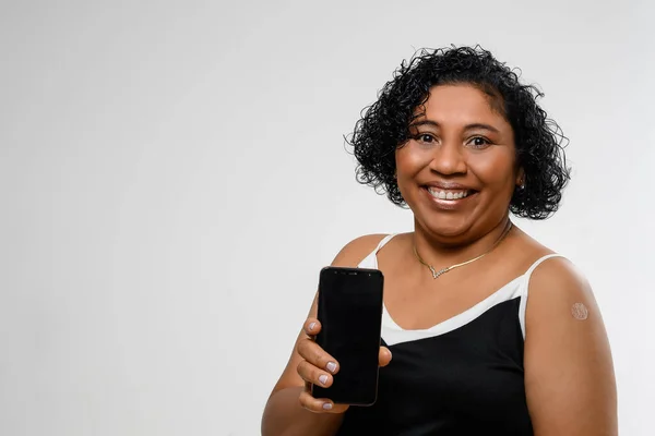 Woman Holds Cell Phone Smiles Face Mask Being Vaccinated Space — Fotografia de Stock