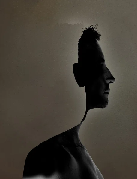 Surrealistic portrait of a young man with cut out profile — Stock Photo, Image