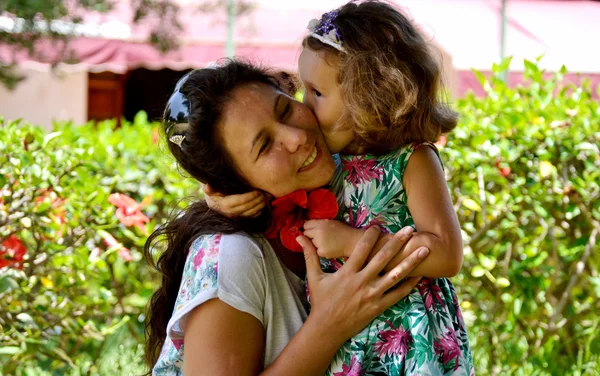 Daughter kissing mother. — Stock Photo, Image