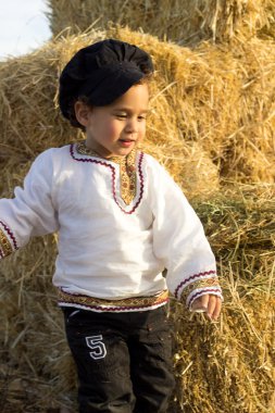 Samanlıkta oynayan çocuk.