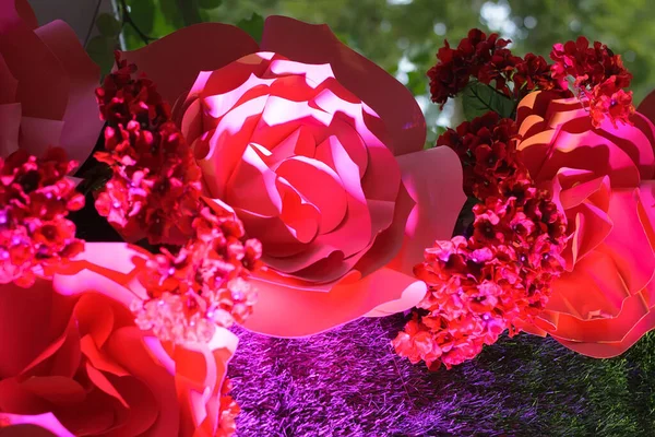 Large red decorative paper flowers with backlight