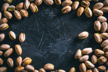 Fıstıklar karanlık bir masaya saçılmış, fotokopi alanı da var. Fındık yemeye hazır. Enerji gıdası. 