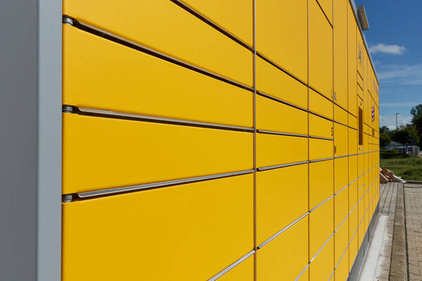 Neckartenzlingen, Germany - June 29, 2021: DHL Packstation where customers can pick up their order themselves and also send packages. Side view.