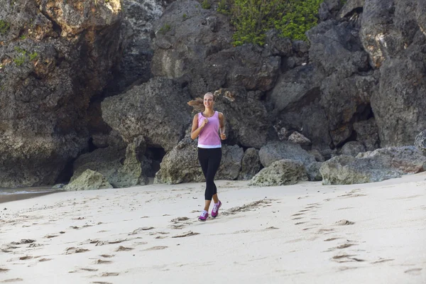 Beautiful girl running on the beach — Stock Photo, Image