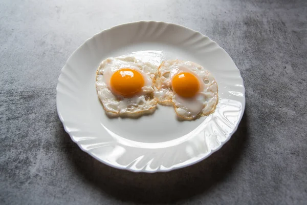 Egg poach sunny side up a healthy food ingredient on a plate. Close up, selective focus.