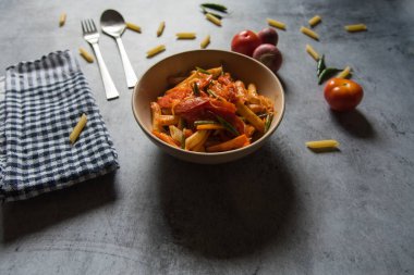 Kırmızı sosta pişirilmiş makarna yemeye hazır. Kapat..