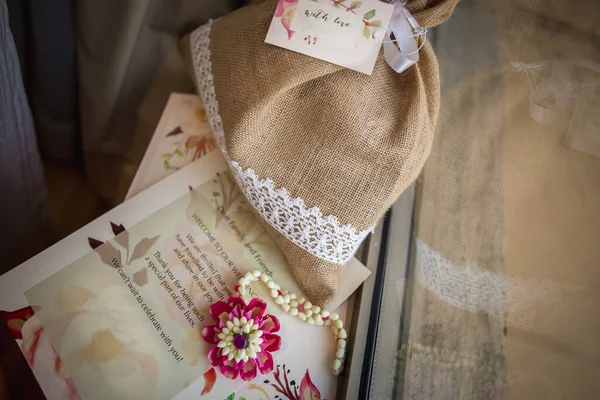 marriage invitation card with beautiful jute bag and flowers