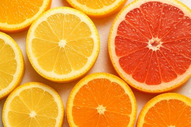 Taze limon, portakal ve greyfurt dilimleri bir arada. Renkli narenciye kompozisyonu tazeliği, vitaminleri ve sağlıklı yaşam tarzını simgeliyor. Yemek tasarımı için mükemmel.