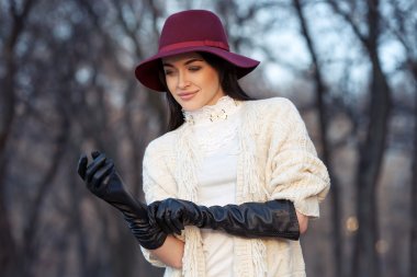 portrait of beautiful girl in hat and leather gloves clipart