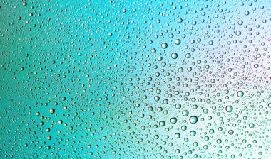 Cyan arka planda küçük damlacıkların dokusu.