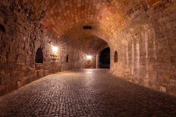 Old medieval stone tunnel under the city fortress at night. Nuremberg. Germany. Bavaria.