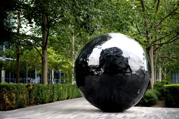 The big black sphere sculpture on the bank of River Thames.