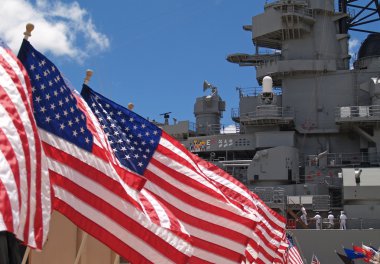US Flags Flying Beside the Battleship Missouri Memorial, with Four Sailors clipart