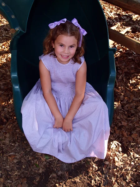 Young Girl Sitting on a Slide — Stock Photo, Image