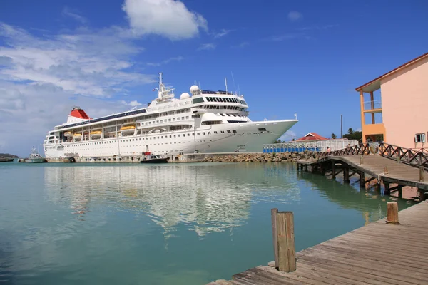 Cruise ship docked in St. Johns Harbour in Antigua Barbuda in the Caribbean Lesser Antilles West Indies with copy space in the sky and on the water. — Stock Photo, Image