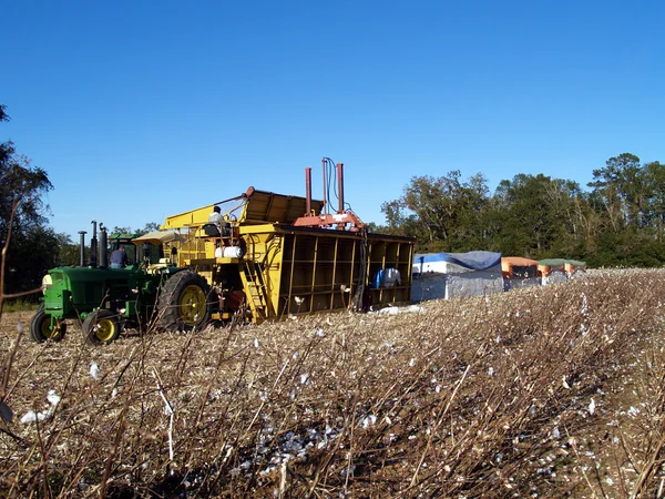 Work site on a farm complete with modules, module builder, boll buggy and tractor. — Stock Photo, Image