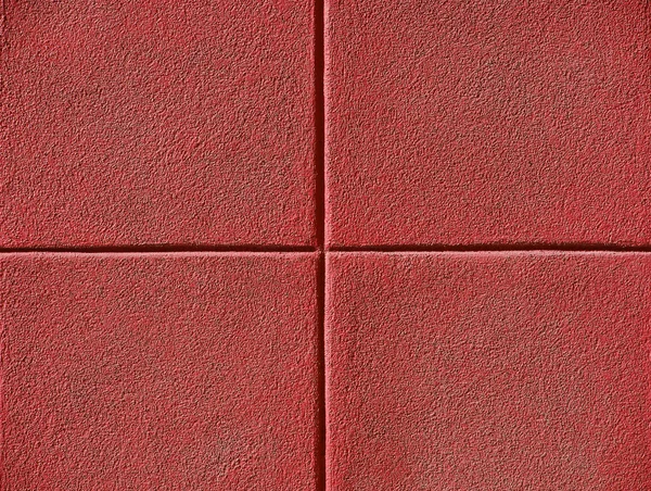 Four red squares on a concrete wall, background and copy space. — Stock Photo, Image