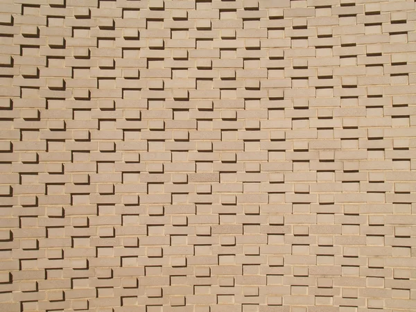 Una pared de ladrillo de color claro, beige multicapa y de varios tamaños . — Foto de Stock