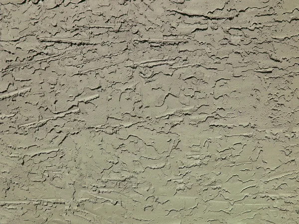 Груба текстурована бетонна або ліпнина зовнішня стіна пофарбована в сірий колір . — стокове фото