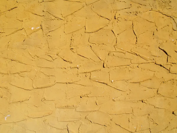 Τραχιά υφή σκυρόδεμα ή το στόκο εξωτερικό τοίχο ζωγραφισμένο ένα χρυσό χρώμα. — Φωτογραφία Αρχείου