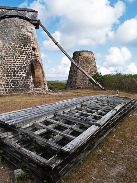 Old windmills behind paddles on Bettys Hope Plantation near Seatons, Pares on Antigua Barbuda in the Caribbean Lesser Antilles West Indies. — Stock Photo, Image
