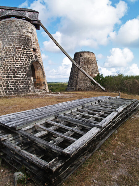 Old windmills behind paddles on Bettys Hope Plantation near Seatons, Pares on Antigua Barbuda in the Caribbean Lesser Antilles West Indies.