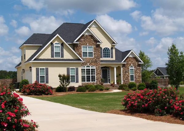 Two story residential home with both stone and board siding on the facade. — Stock Photo, Image