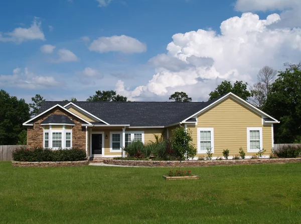 One story residential home with vinyl siding and brick or stone on the facade. — Stock Photo, Image