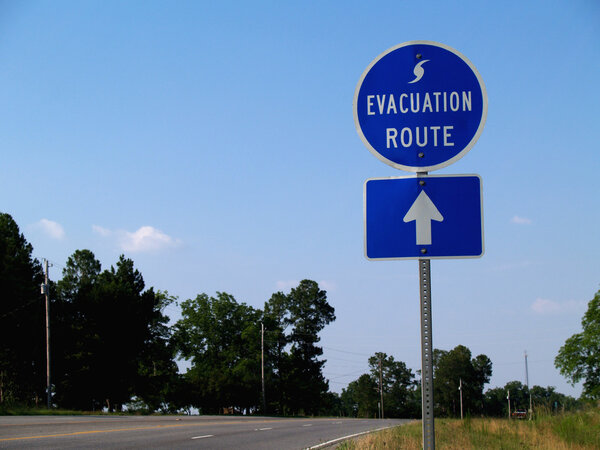 Blue hurricane evacuation route sign along a highway.