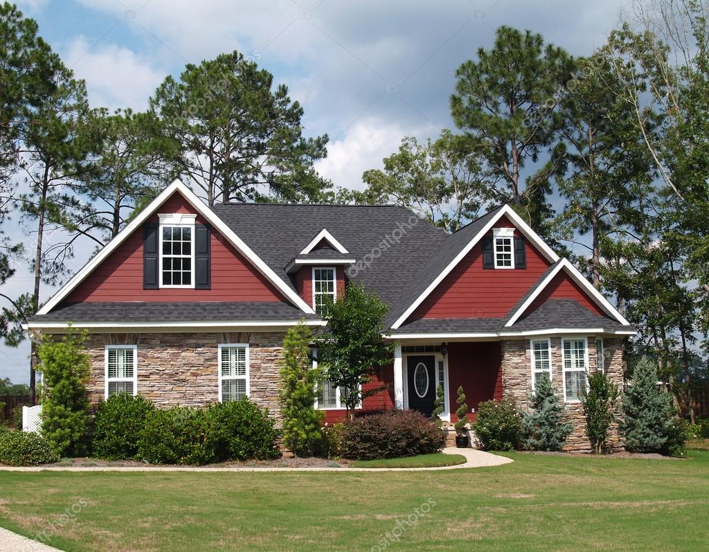 Two story residential home with both stone and board siding on the