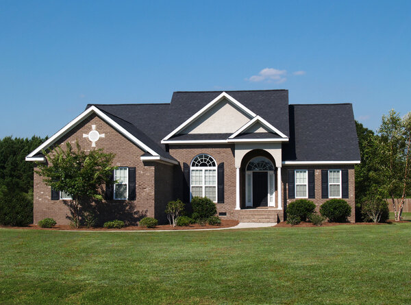 One story new brown brick residential home.