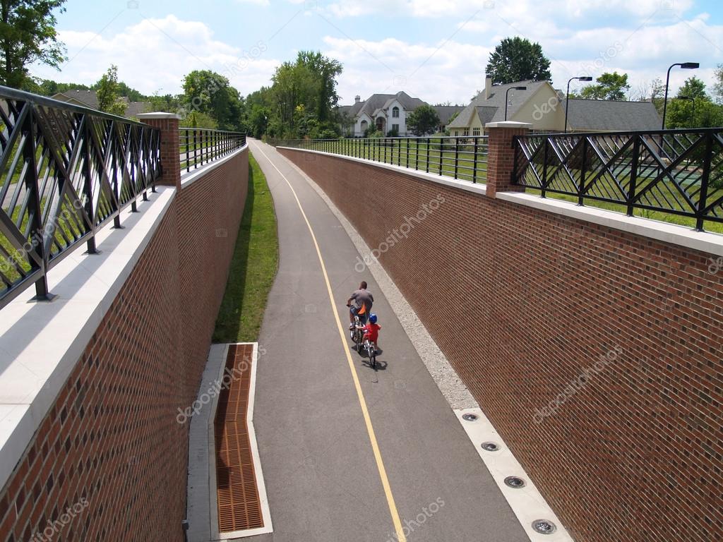 Father and son riding bikes on the Monon Greenway Trail in Carmel