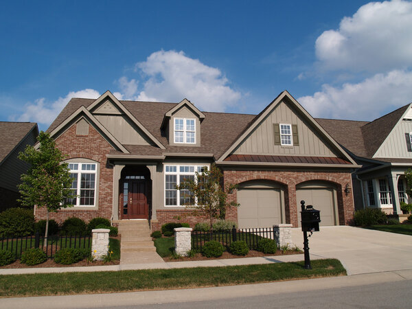 Small home with double garage in a neighborhood where the houses are built close together with very little yard.