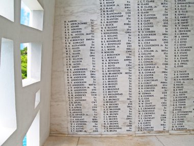 Names on the wall of the USS Arizona Memorial  beside a unique window, at Pearl Harbor in Honolulu, Hawaii. clipart