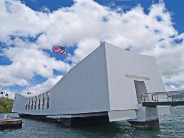 US Flag flying above the USS Arizona Memorial in Pearl Harbor, Honolulu, Hawaii. clipart