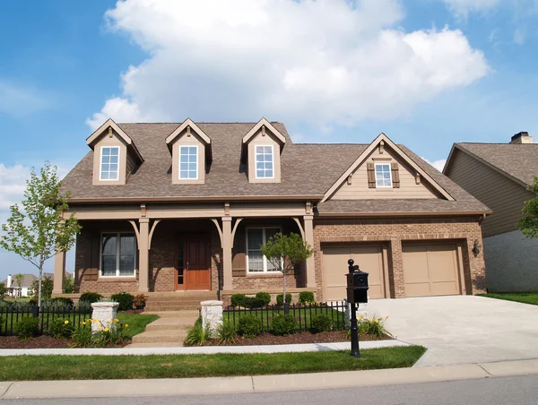 Small two story brick home with porch and a garage in front containing plenty of copy space, — Stock Photo, Image