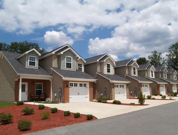 Two story low income retirement homes with the garage in the front. — Stock Photo, Image