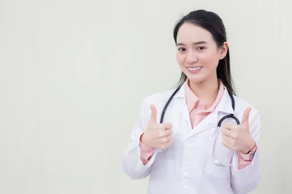 身穿医疗服的亚洲年轻女医生的手在白种人的衬托下鼓起勇气 — 图库照片
