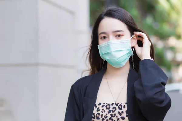 Premium Photo  Beautiful asian woman walking in the city wear colorful  sweaters long hair and medical masks