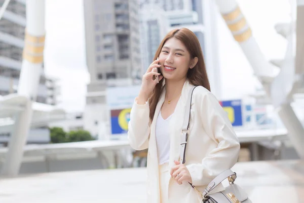 Asian Business Woman White Suit Smiles Holds Smartphone Her Hands — Stock Photo, Image