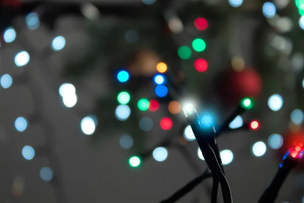 Blurred and multicolored lights garlands as a background. New Year and Christmas lights
