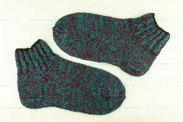 Warm and beautiful socks knitted of woolen threads. Hand tied socks. Knitting as a hobby and a quarantined business. Warm and unique handmade socks