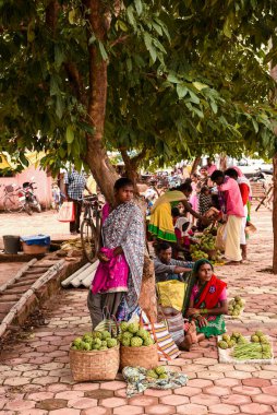 Bastar, Chhattisgarh, Hindistan / 28 Eylül 2017: Kabile kadınları Jagdalpur yakınlarındaki bir pazarda Custard Apple, Sitafal satıyor.  