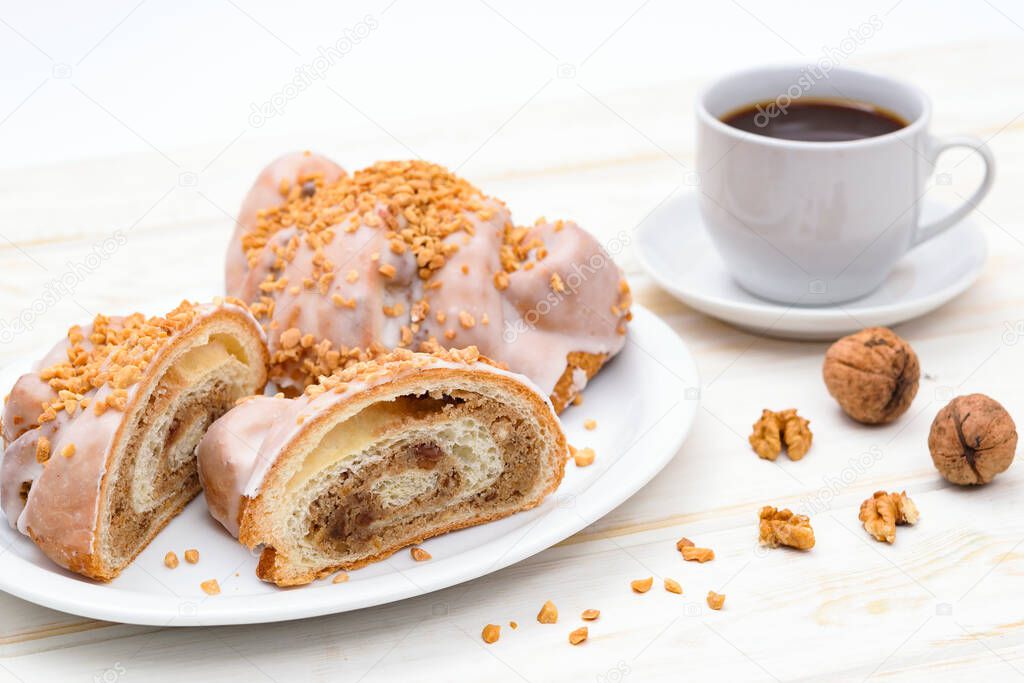 Tasty traditional polish croissants  - Croissant of Saint Martin (Rogal Swietomarcinski) with white poppy seeds, nuts and cup of coffee.