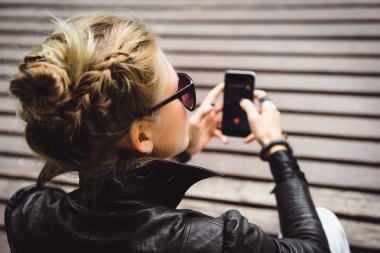 kadının elindeki cep telefonu ile